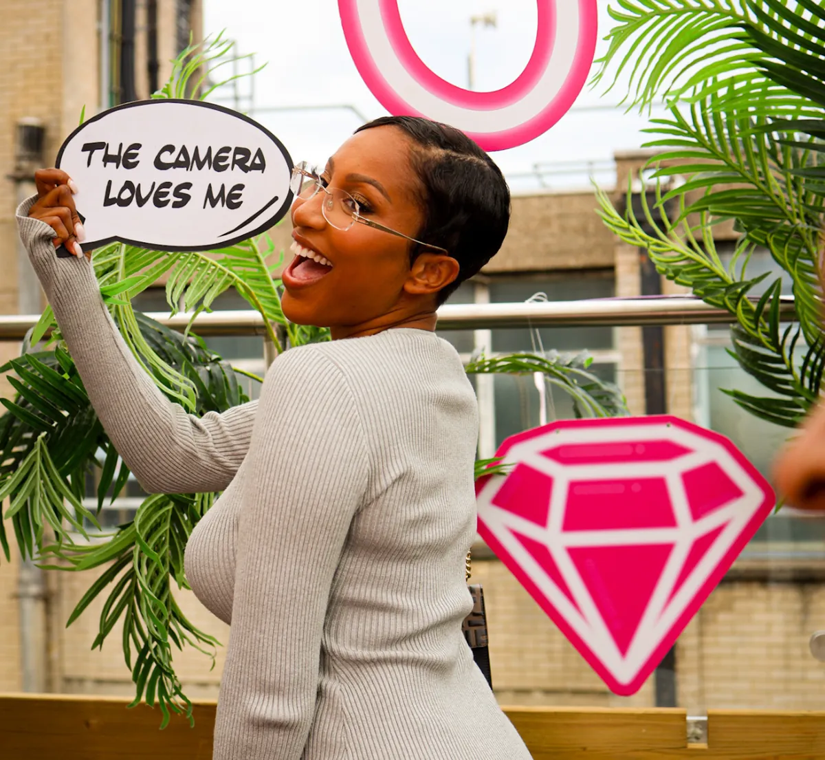 A guest laughing with a 'the camera loves me' prop