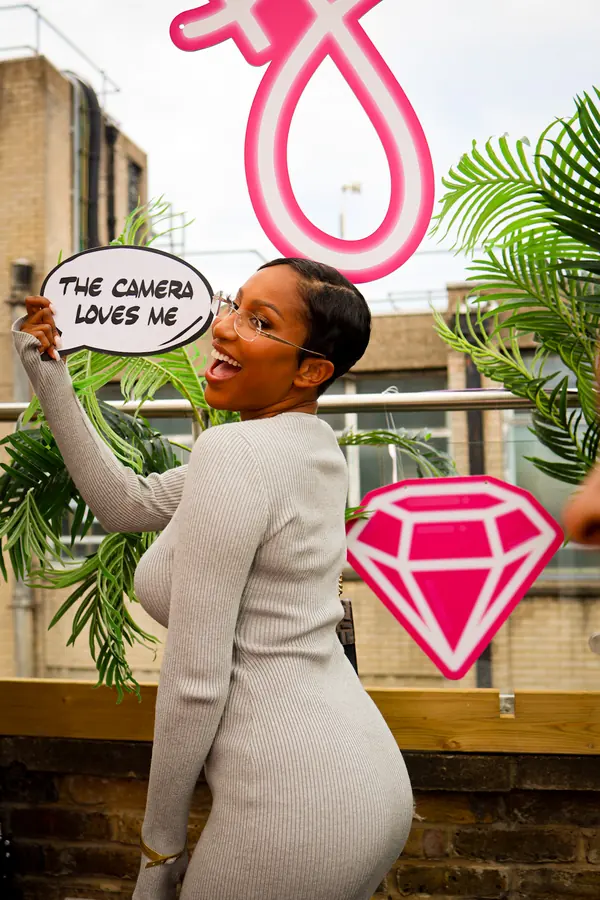 A guest laughing with a 'the camera loves me' prop