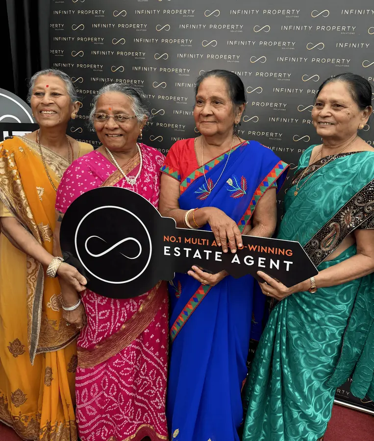 A family celebrating an estate agent award win