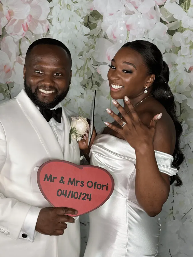 Newlyweds holding a Mr and Mrs sign