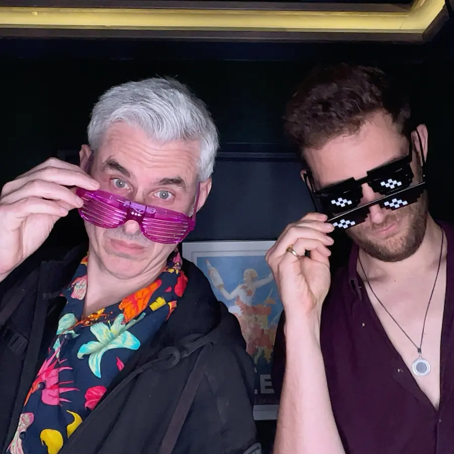 Two guests in novelty party glasses