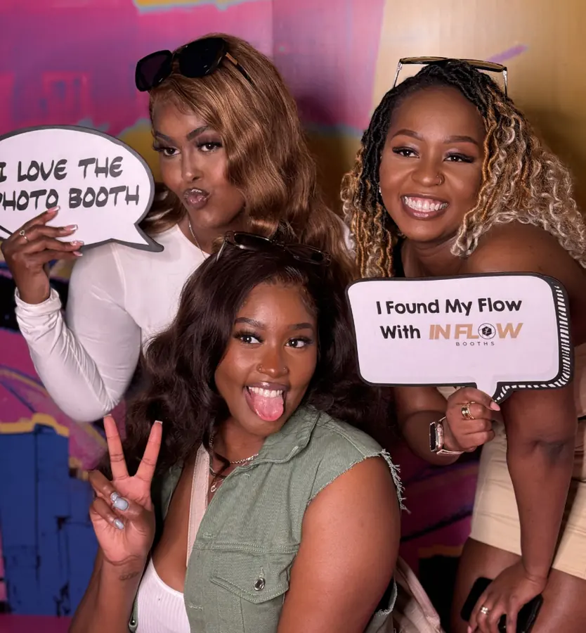 Friends holding 'I found my flow with In Flow' props