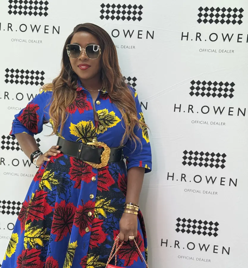 A guest in a bold print dress at an HR Owen event