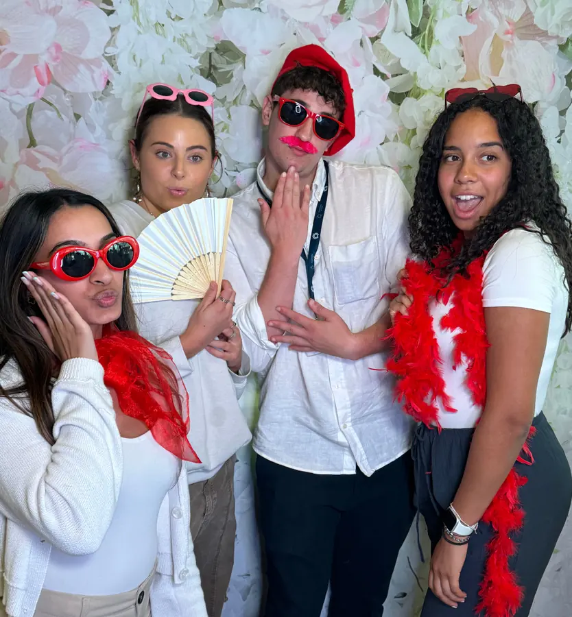 Friends with feather boas, fans and red sunglasses