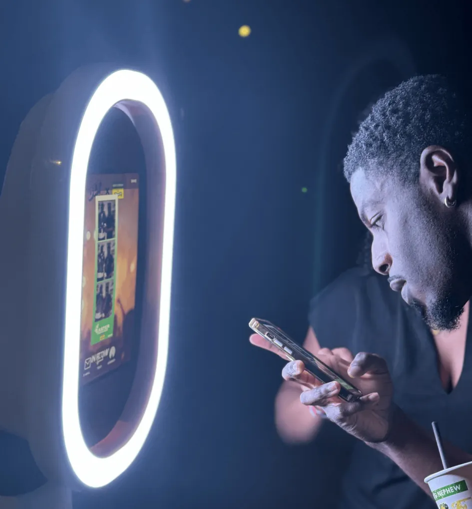 A guest checks his photos beside the glowing booth